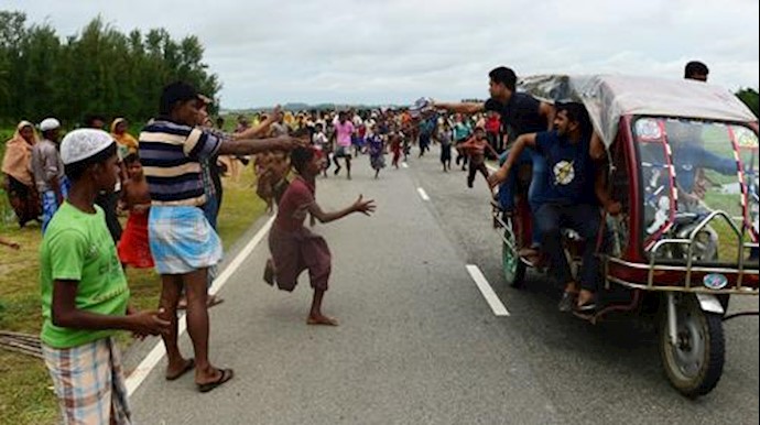  'ZAMANRohingya Muslim refugee children follow a vehicle with relief supplies near the Bangladeshi town of Teknaf on September 10, 2017'