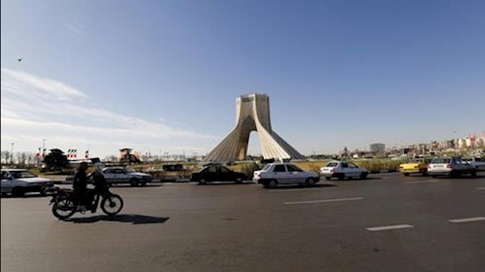  'Motorists drive past Azadi Tower in Tehran on January 13, 2018.'