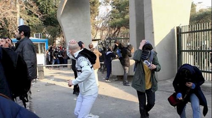  'Iranian students run for cover from tear gas at the University of Tehran during a demonstration'