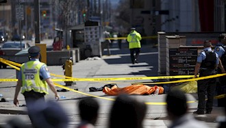  'A tarp covers a body after a van plowed into pedestrians in Toronto Monday afternoon' Title='A tarp covers a body after a van plowed into pedestrians in Toronto Monday afternoon'