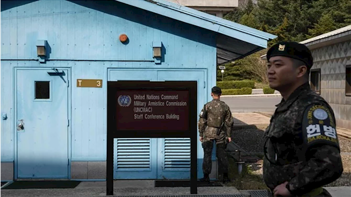  'A South Korean soldier stands guard before a United Nations Command Military Armistice Commission meeting hut in the truce village of Panmunjom within the Demilitarized Zone that separates North and South Korea. '