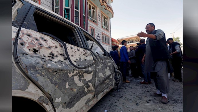  'Afghan men inspect the site of a suicide bomb blast in Kabul, Afghanistan April 22, 2018'