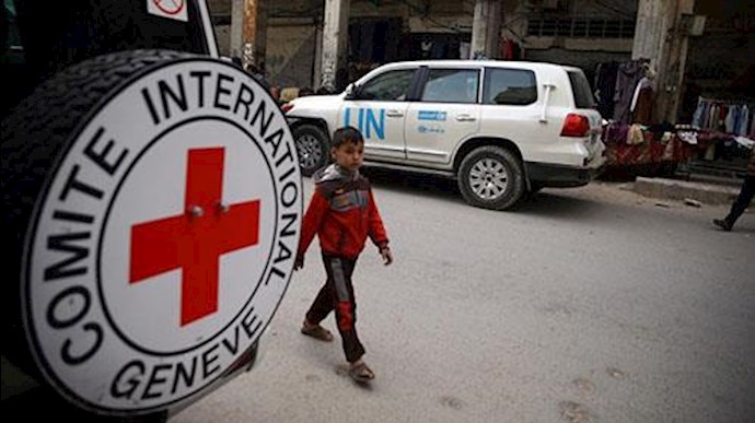  'A Syrian child is seen walking near International Red Cross vehicle in the rebel-held city of Douma.'