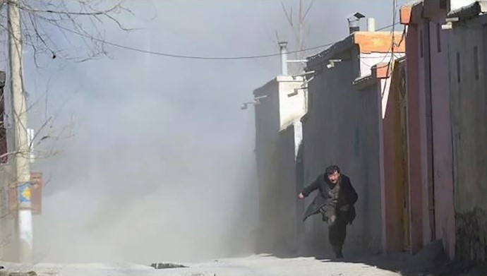  'An Afghan man runs away as dust blows in the aftermath of a blast..JPG'