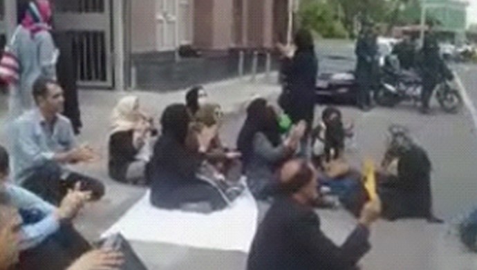  'A group of people whose investments has been taken away, gathered in protest'