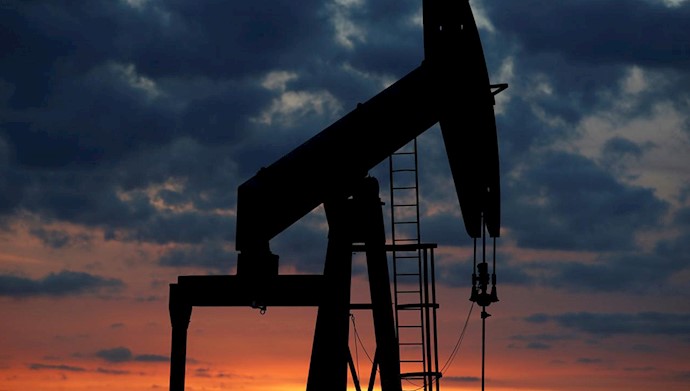  'Oil pump are seen at sunset outside'